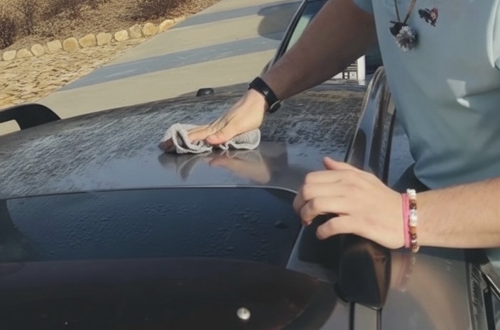 Hand drying a freshly washed car